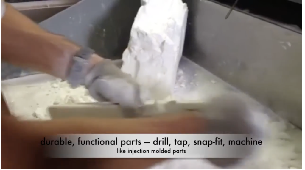Removing an SLS 3D printed part from nylon powder at 3DPrototype.com’s Ontario facility.